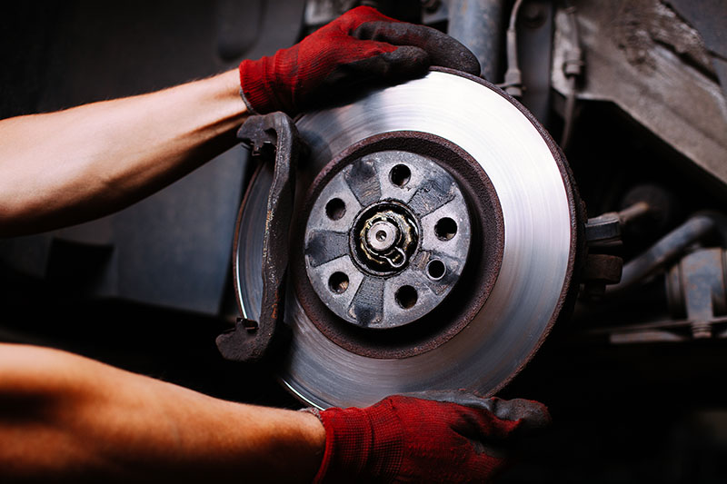 Mobile mechanic in Albuquerque performing precision brake repair on a vehicle's braking system