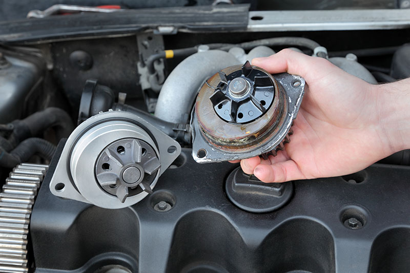 Mobile mechanic in Albuquerque repairing a leaking radiator to prevent engine overheating